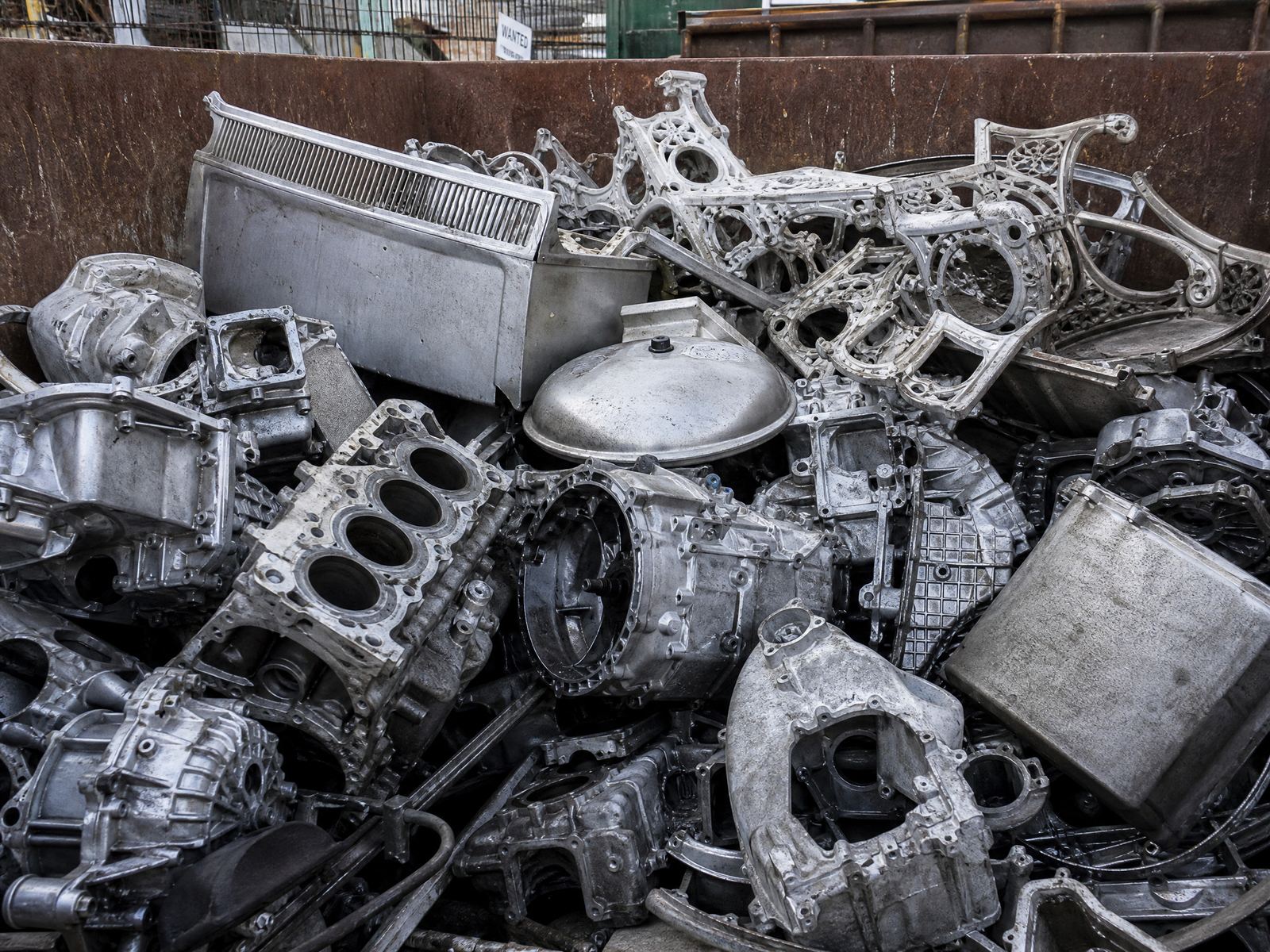 Cast aluminum scrap — engine blocks, housings, and castings in a hopper
