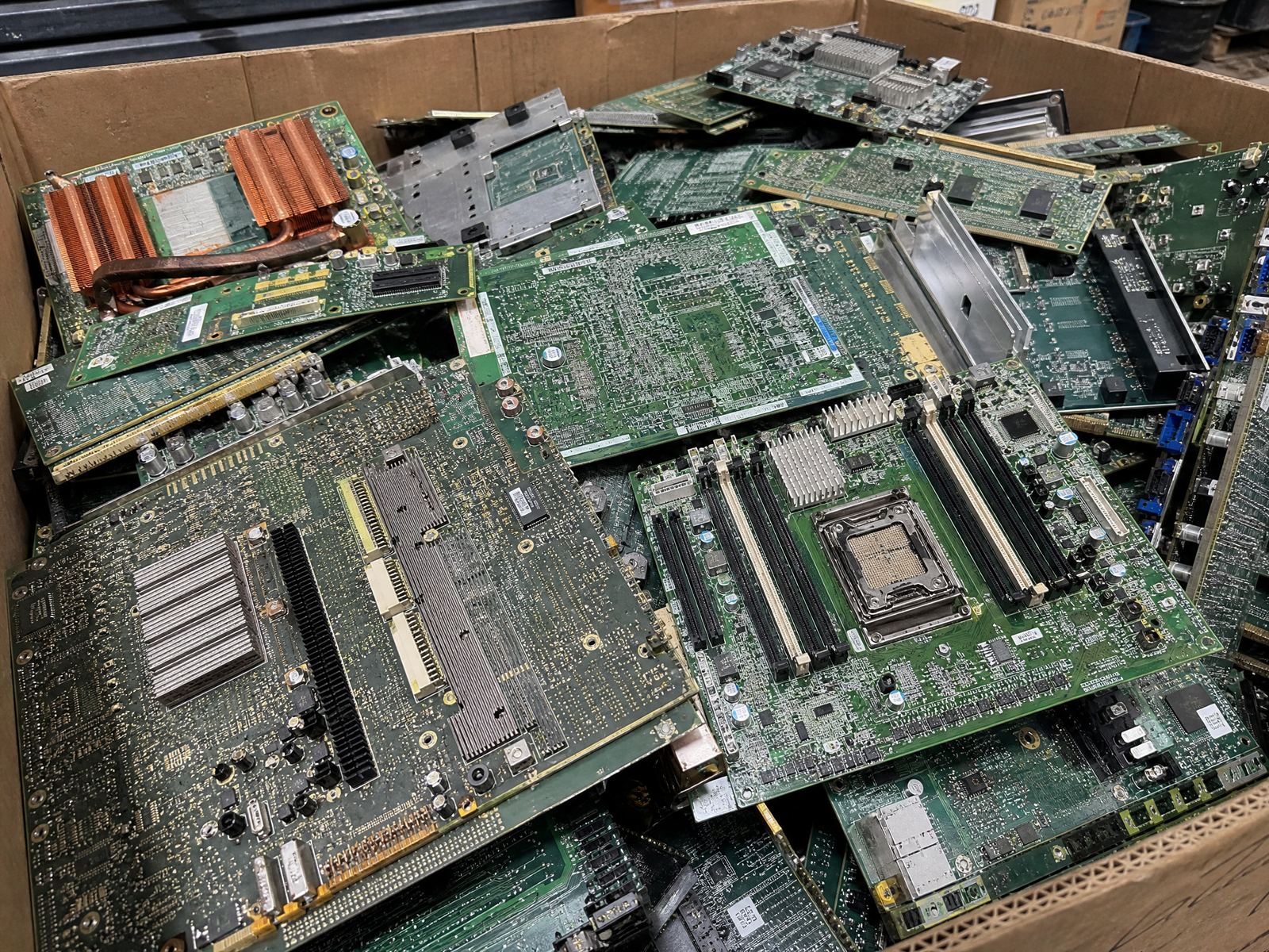 Scrap circuit boards and motherboards in a gaylord at an e-waste facility