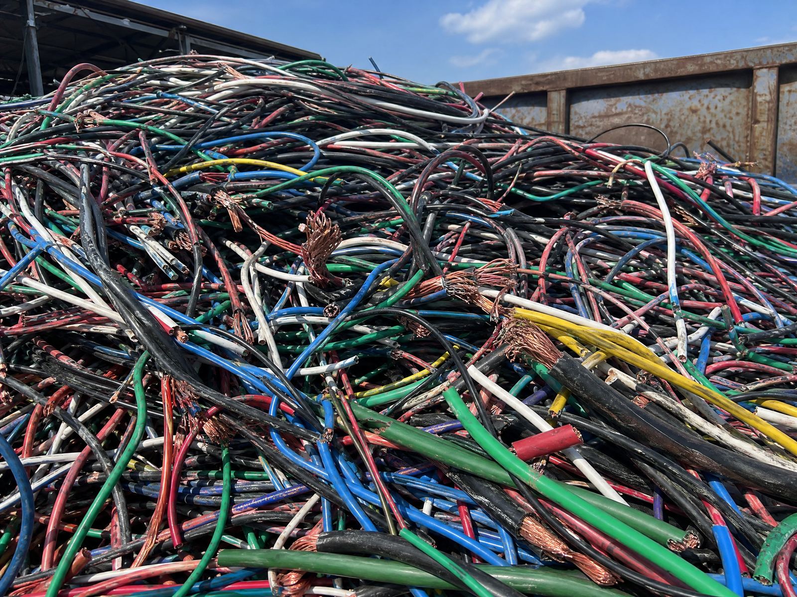 Pile of scrap insulated copper wire — THHN, Romex, and stranded cable