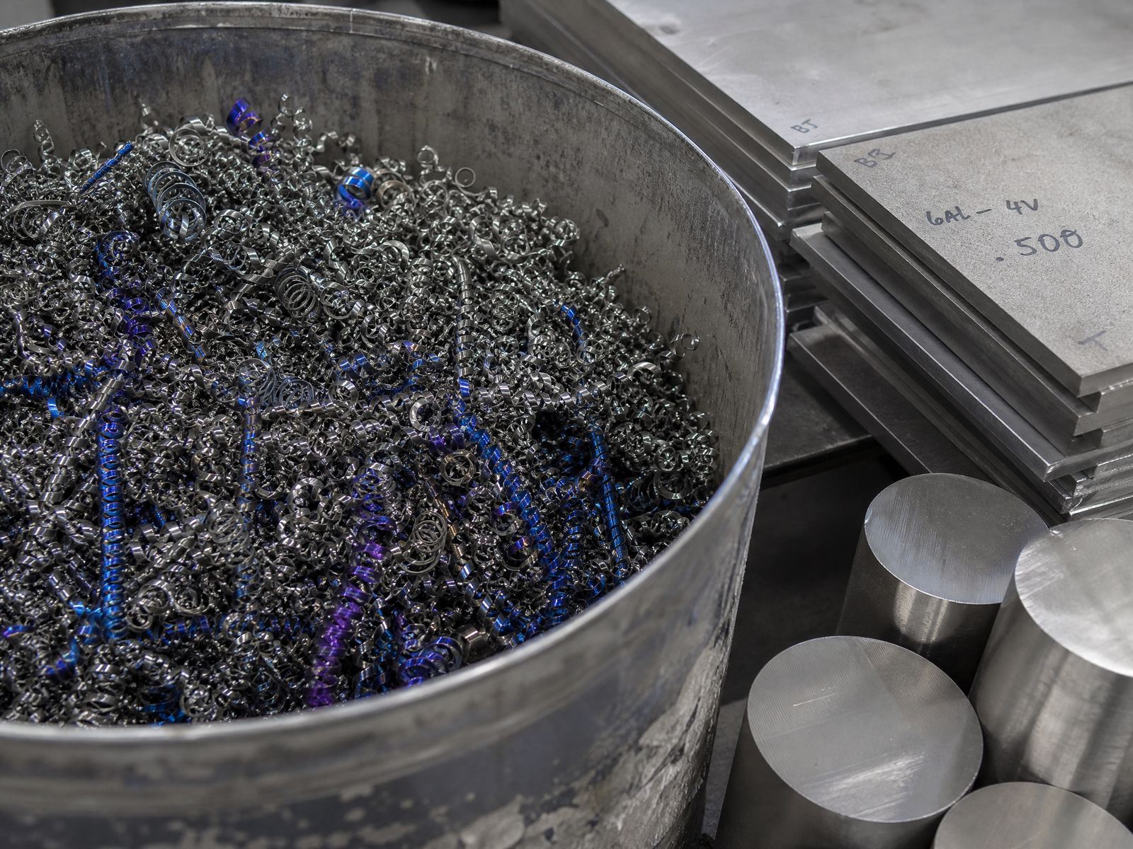 Titanium turnings and plate offcuts from an aerospace machine shop